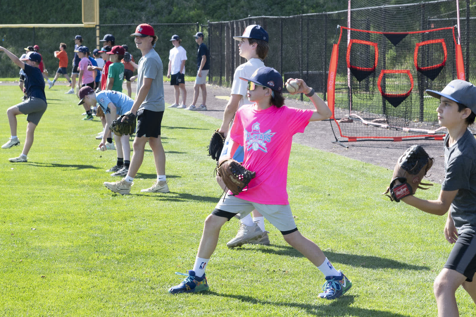 Campers in a line practicing throwing drills at Bootcamp
